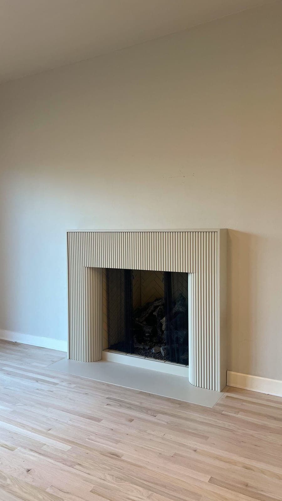 Cast stone custom florenza fireplace in Meadow Mist — living room