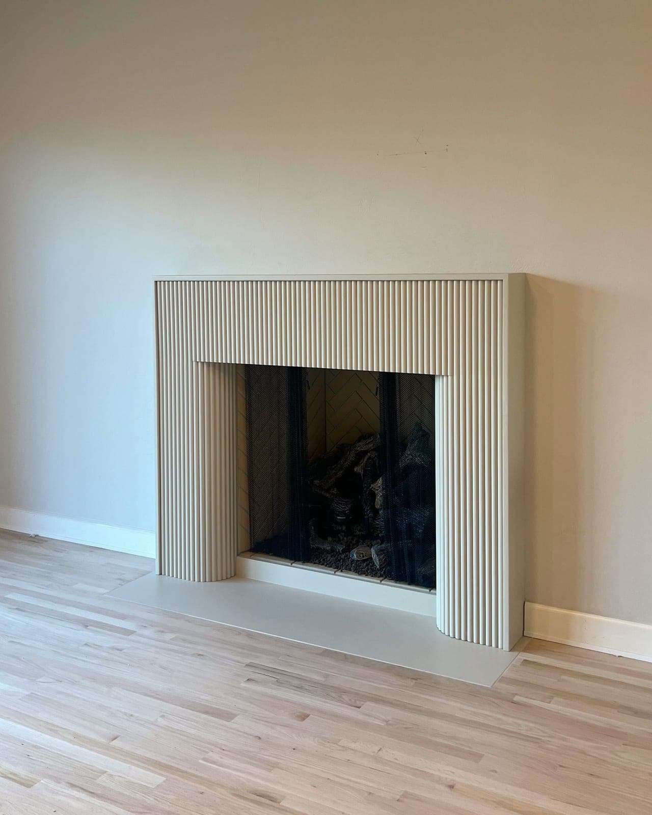 Cast stone custom florenza fireplace in Meadow Mist — living room
