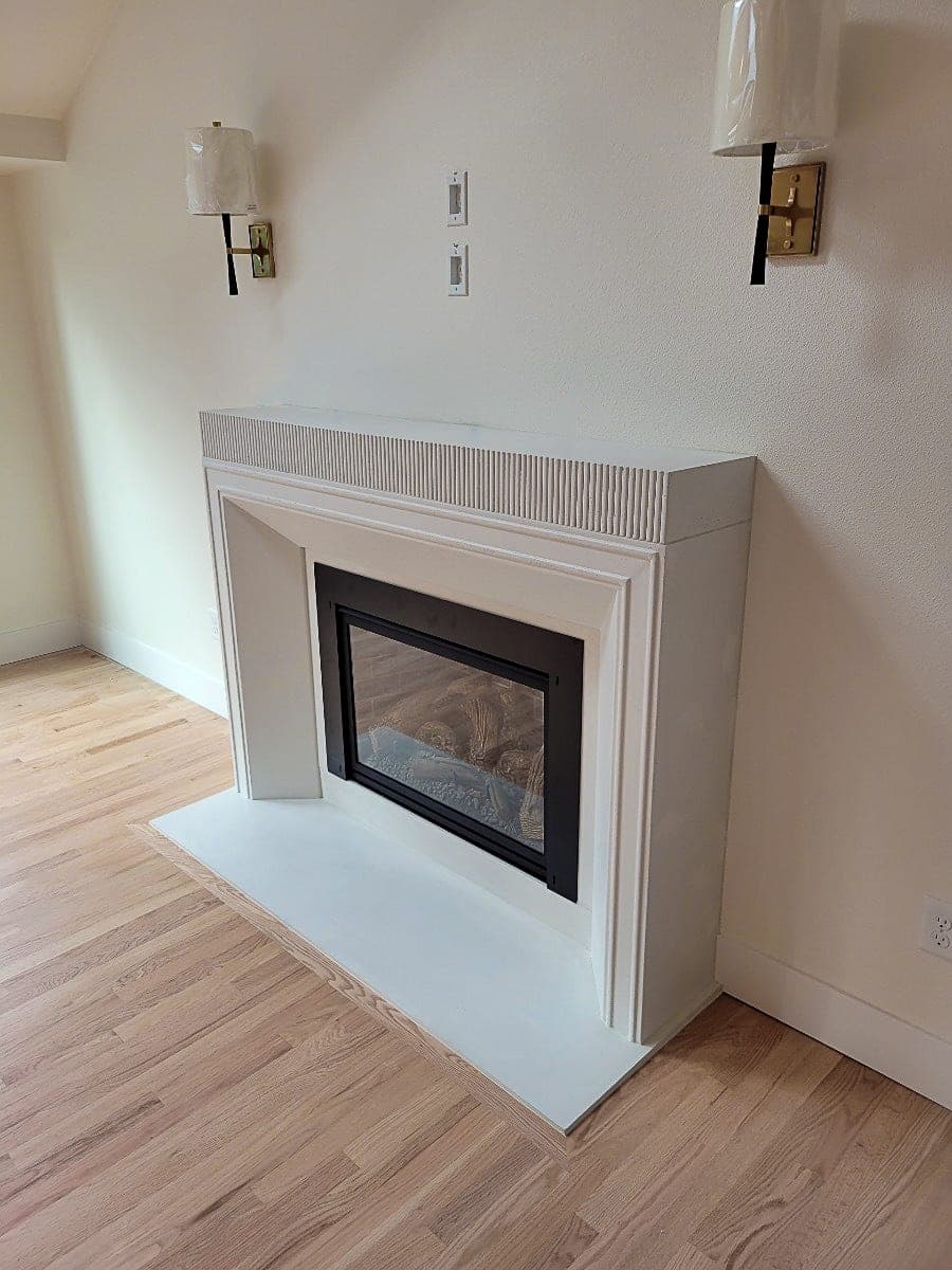 Cast stone custom fireplace in Italian White — living room