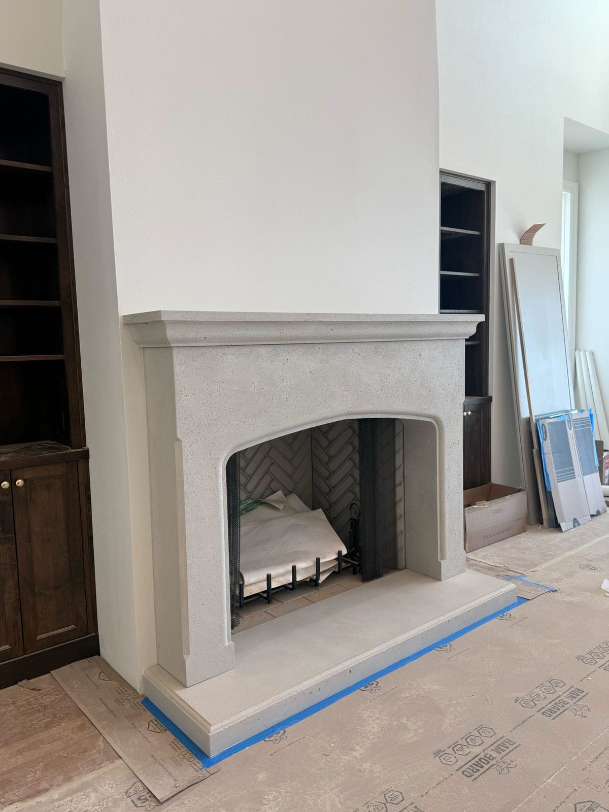 Cast stone custom fireplace in Subtle Gray travertine texture — library