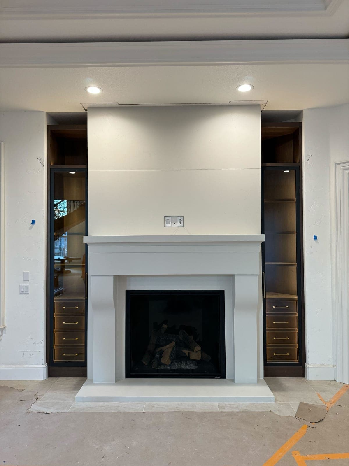 Clean-lined modern fireplace surround with minimal ornament and horizontal stepped mantel in fresh cream finish.