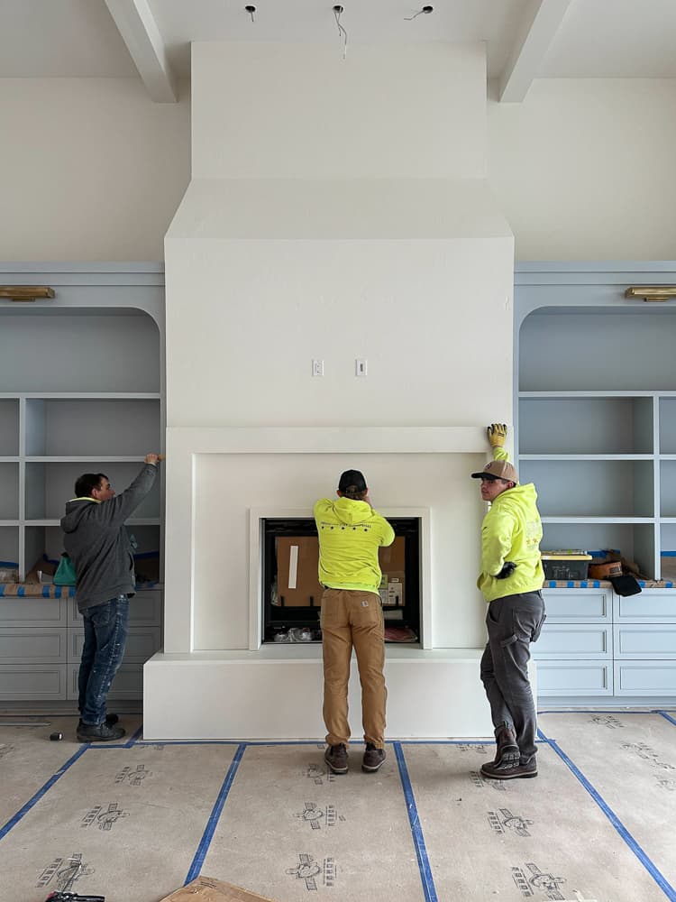 Cast stone fireplace surround installed in a Charla Ray-designed residence.