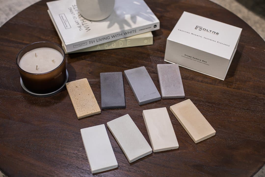 Oltre cast stone sample box — eight finish swatches in a wood crate.