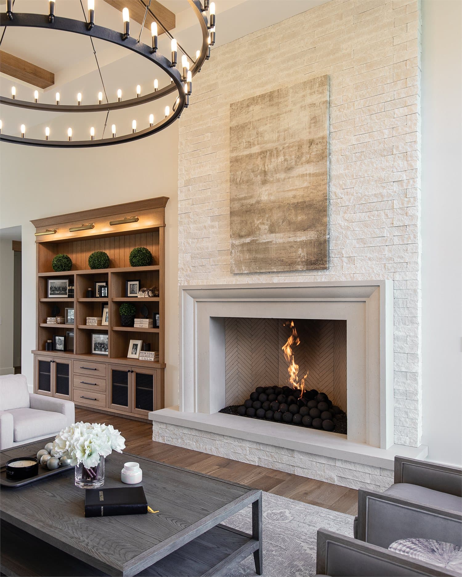 Installed Oltre cast stone fireplace surround showing the carved profile and fine surface grain of GFRC cast stone