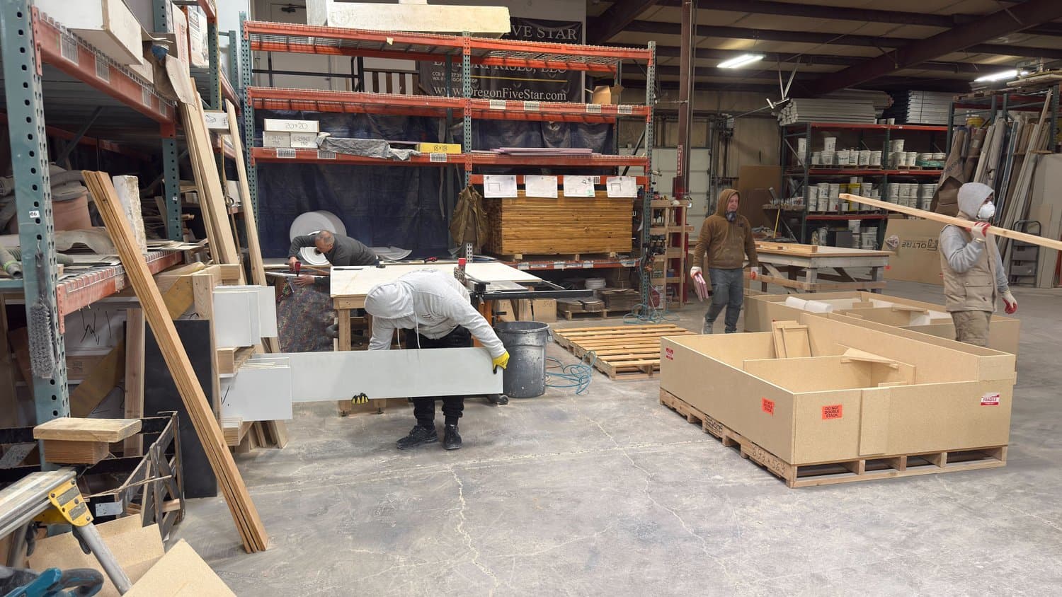 Oltre team crating cast stone pieces on the Salem workshop floor for freight.