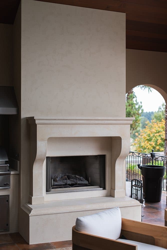 Crainic residence — custom cast stone fireplace surround with hearth matched to an existing great-room piece.