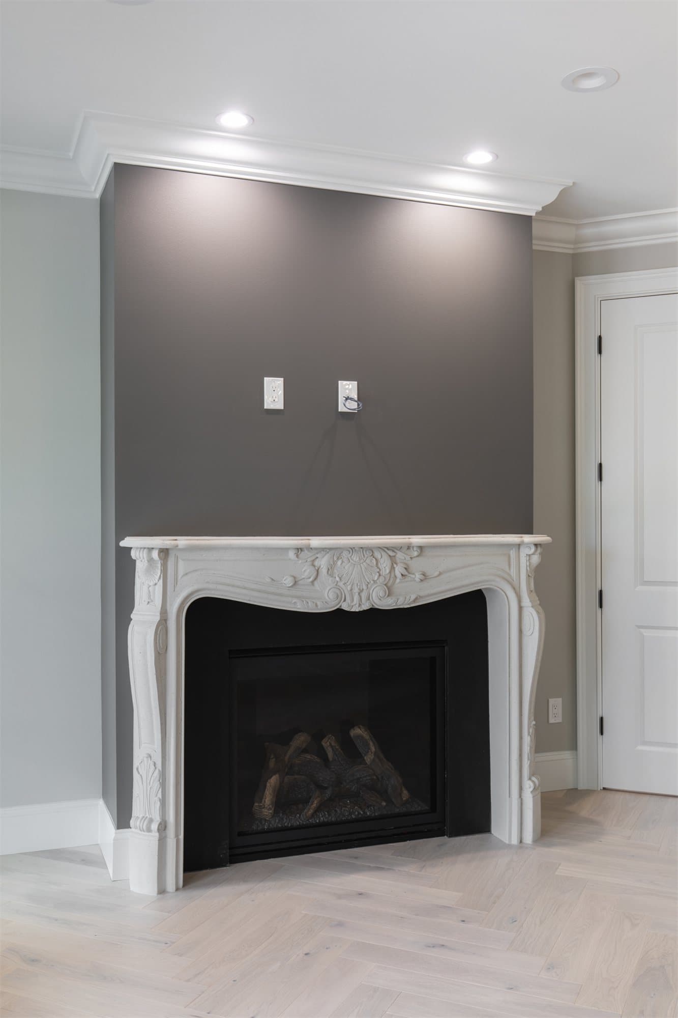 River Road Villa — Newport cast stone surround installed alongside built-in shelving.