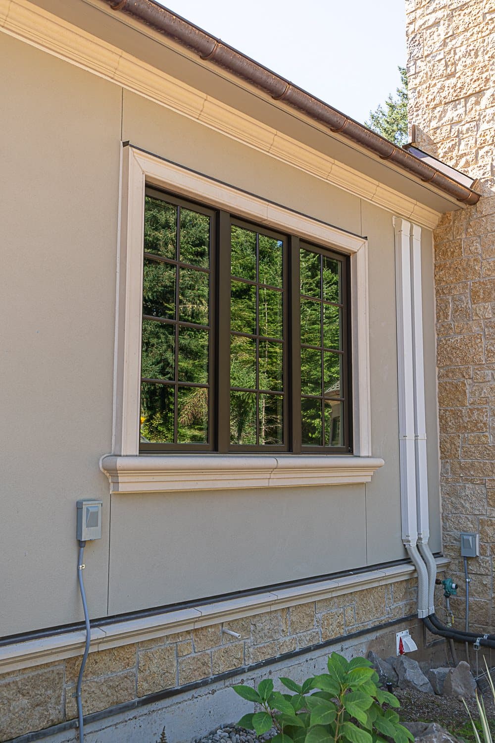 Young Residence — whole-house exterior with cast stone window sills, cornice, and trim program.