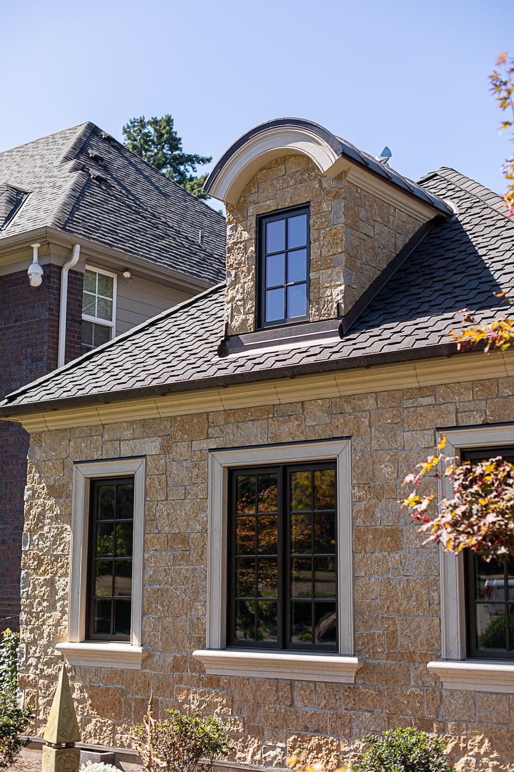 Young residence — whole-house exterior with cast stone window sills, cornice, and trim program.