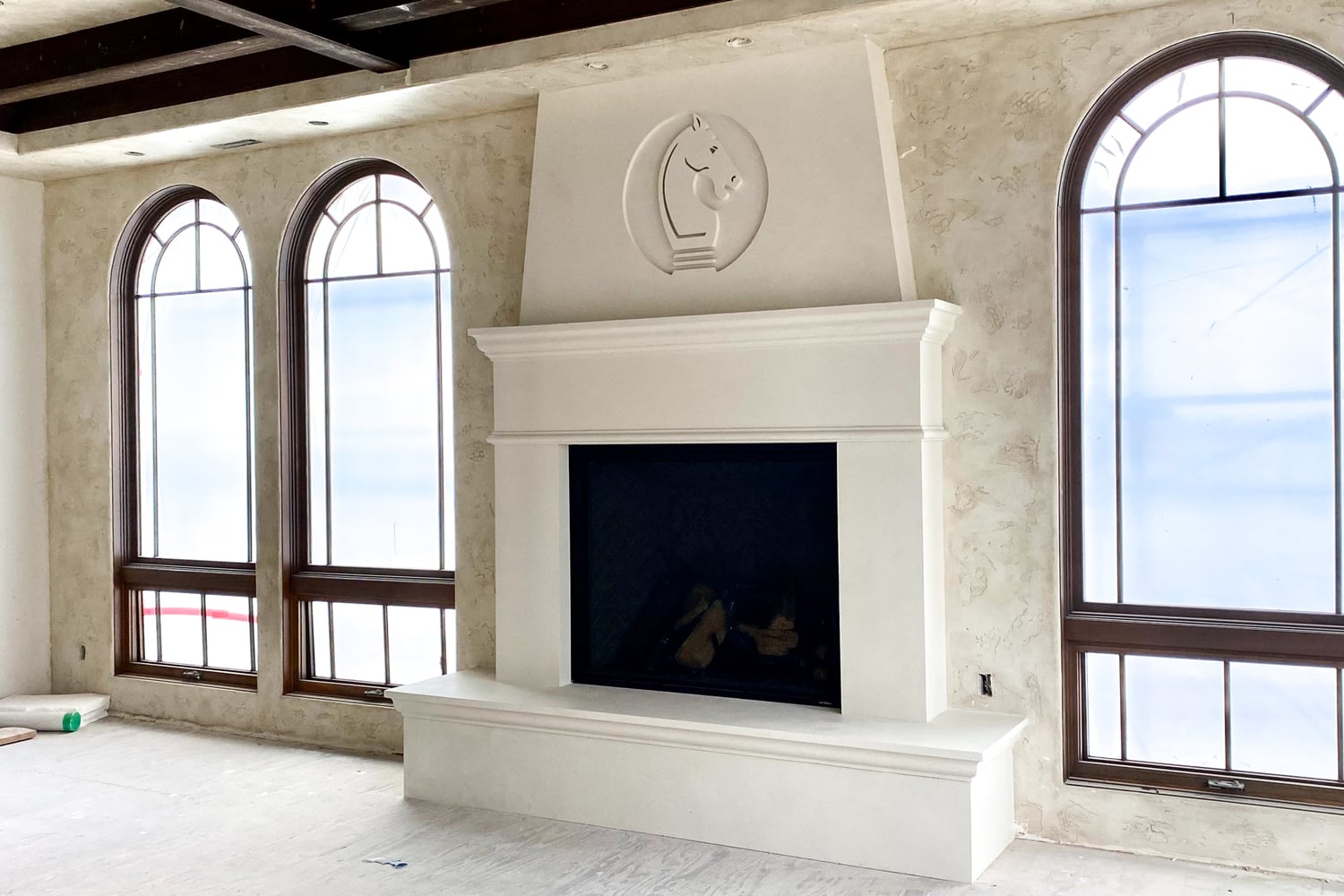 Installed cast stone fireplace surround in a residential family room
